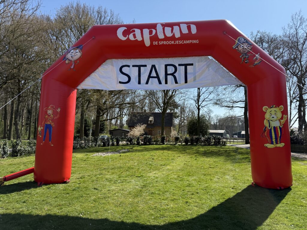 Rode opblaasbare startboog op een grasveld